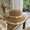 Beige woven straw hat with a light-colored bow ribbon details Picture